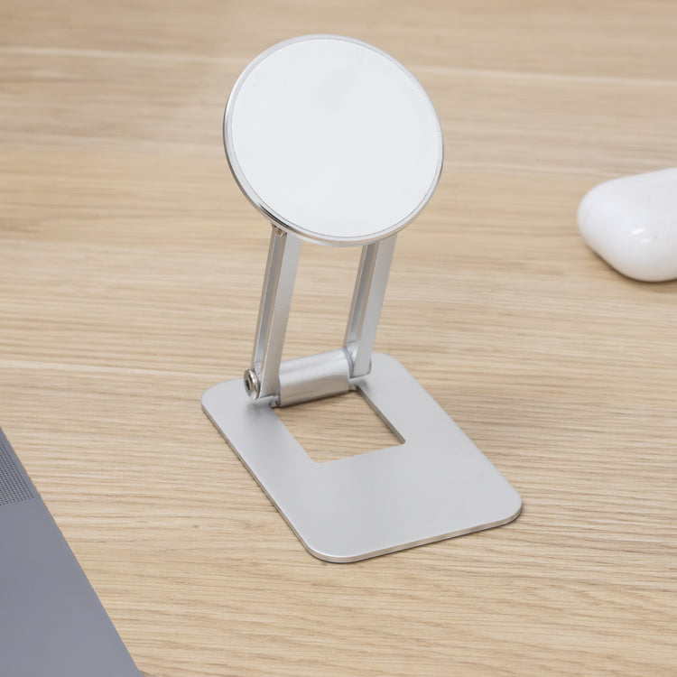Phone stand on a wooden desk with a laptop and mouse in the background