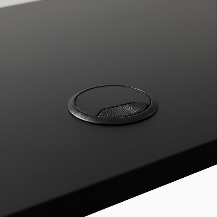 Black grommet hole on black desk