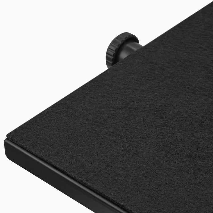 Close-up of a black felt-covered foot rest