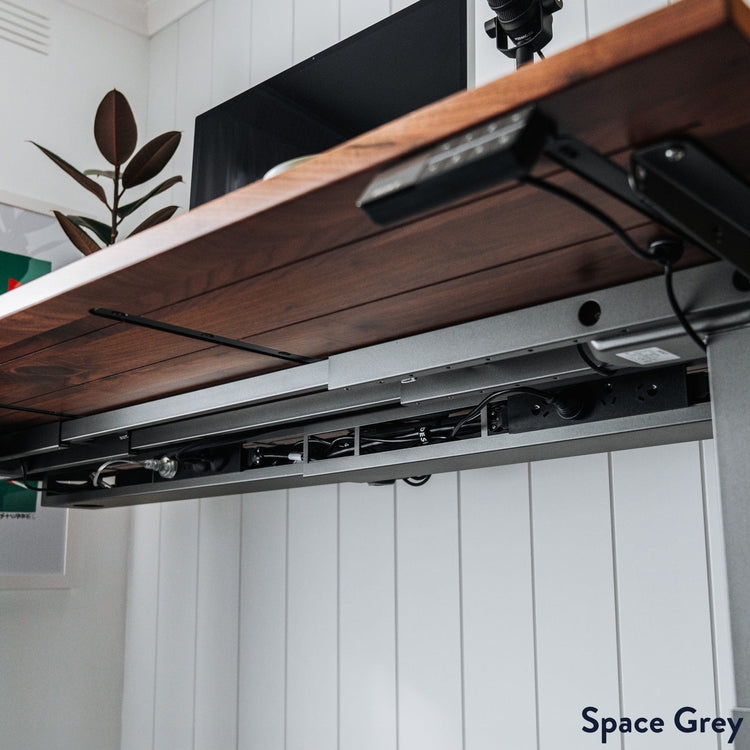 Desky integrated cable and power channel in space grey under desk setup