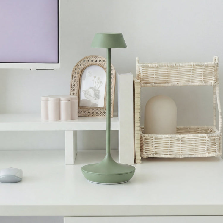 Green Desky nimbus cordless lamp in sage on top of desk