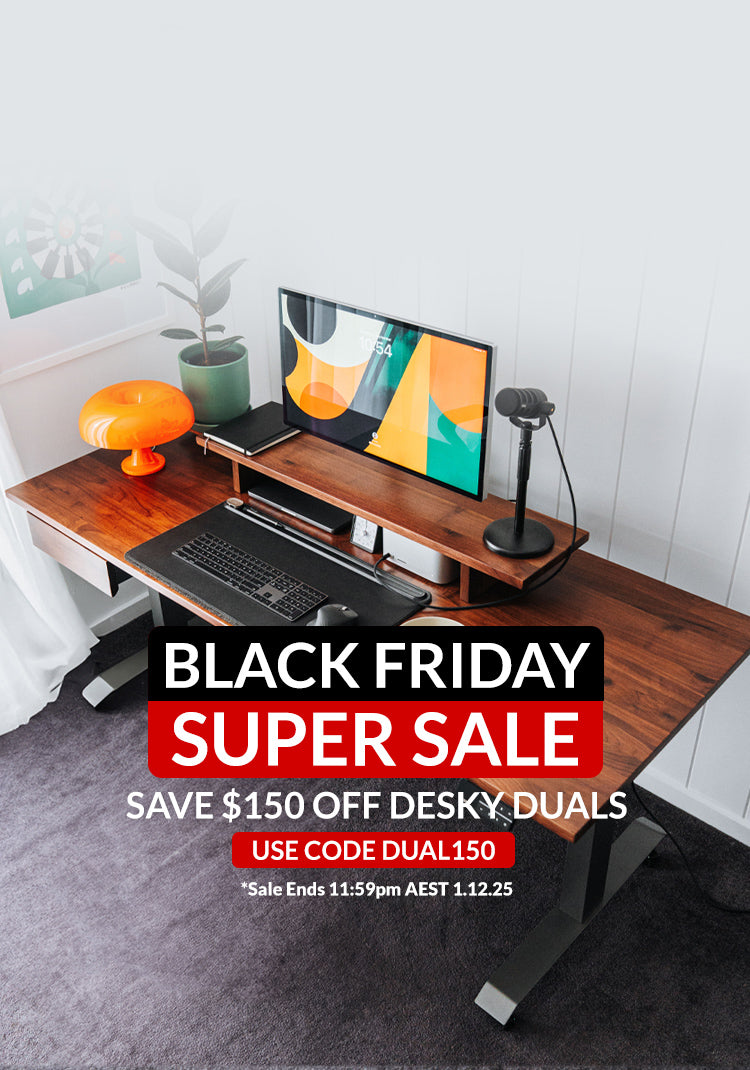 Wooden desk setup with computer equipment and Black Friday sale text overlay.