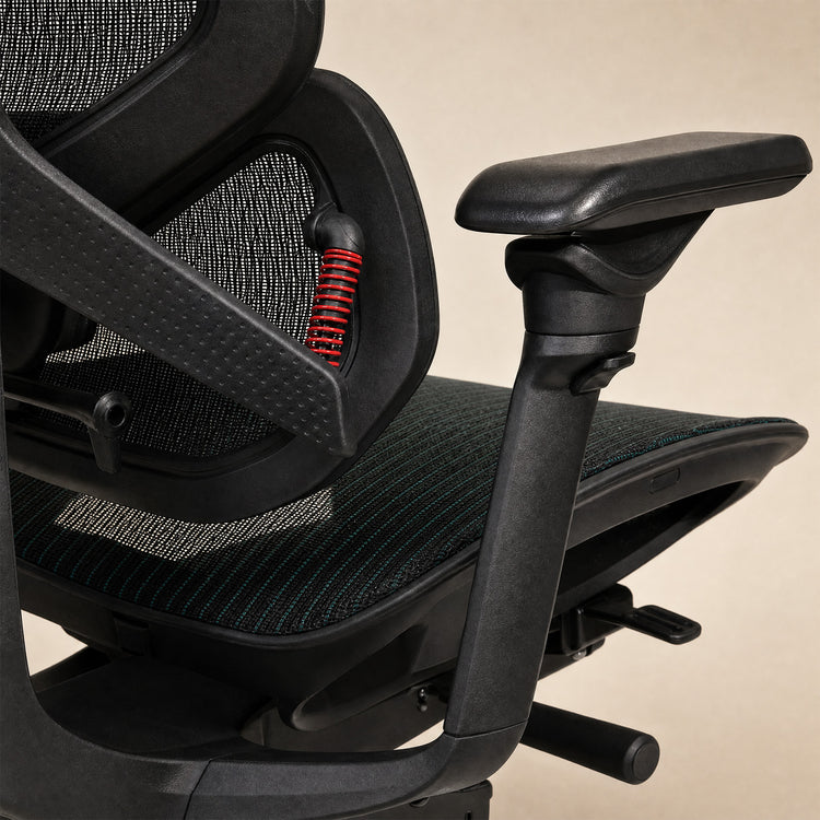 Close-up of a black Contourra ergonomic office chair with mesh backrest, padded armrests
