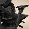 Close-up of a black Contourra ergonomic office chair with mesh backrest, padded armrests