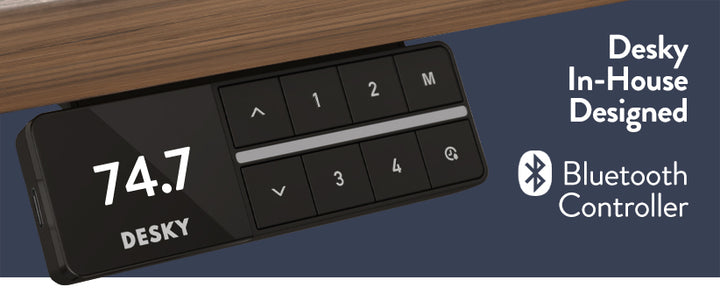 Desky Bluetooth controller with digital display on a wooden surface