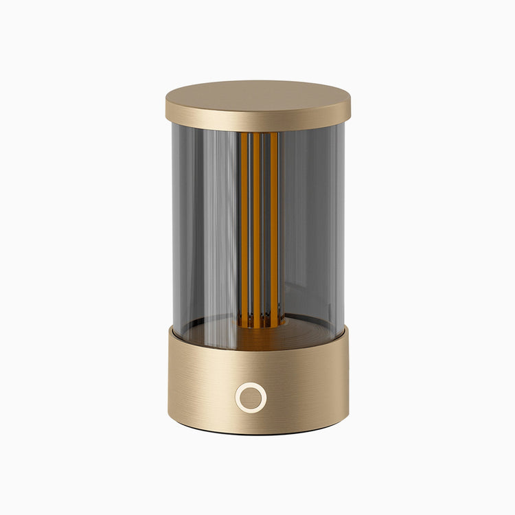 Modern cylindrical lamp with gold finish on a white background