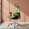 Green office chair with headrest against a peach-colored wall