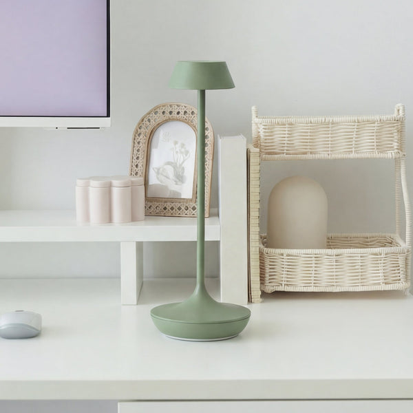 Green Desky nimbus cordless lamp in sage on top of desk