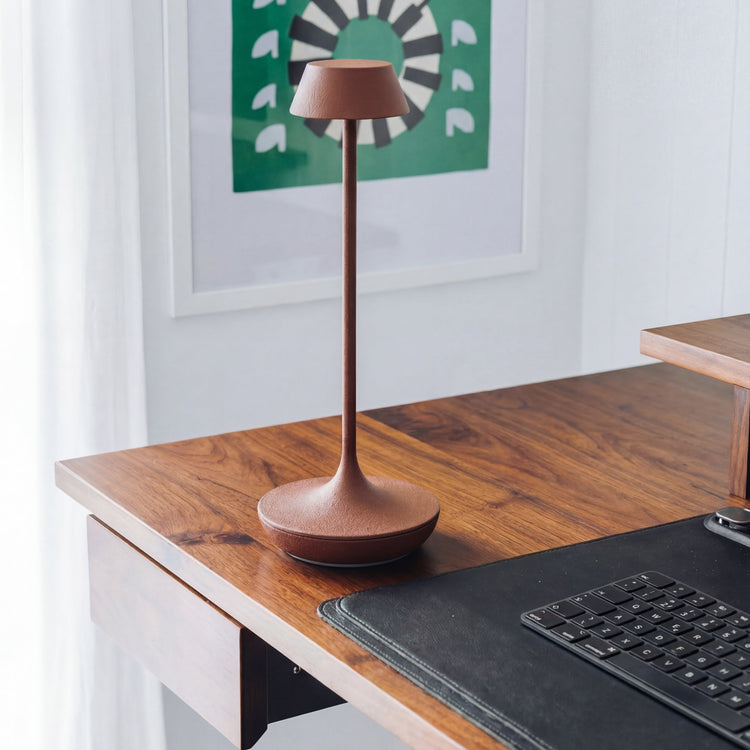 Nimbus cordless lamp in terracotta on top of desk