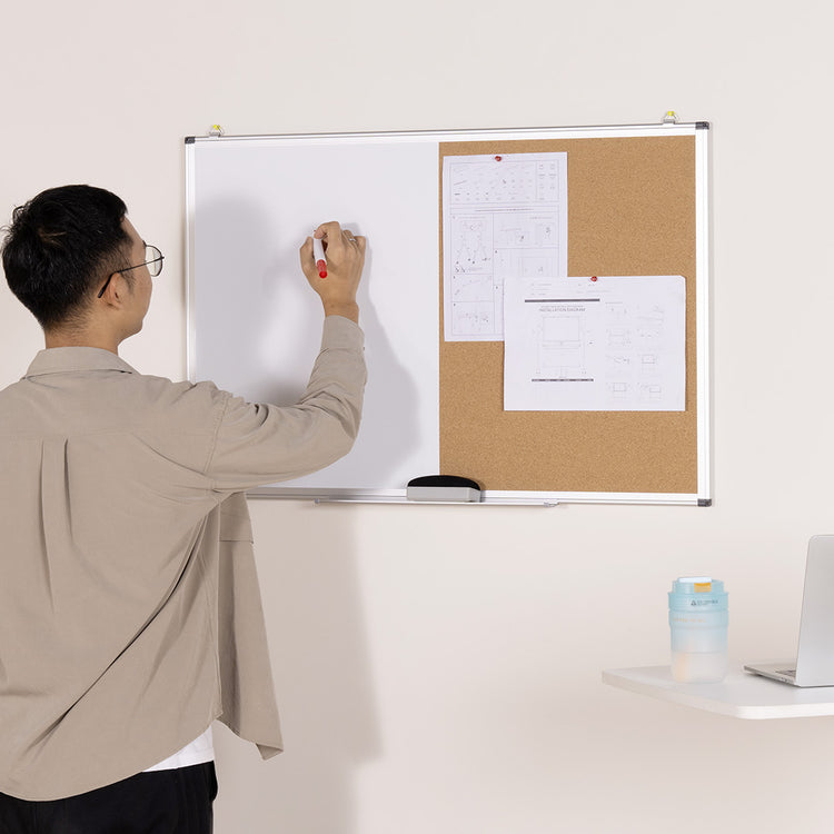 Man writing on desky whiteboard and pinboard combo