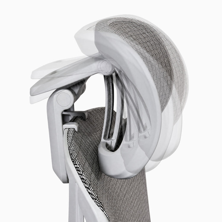 Close-up of an ergonomic office chair showing the headrest and white frame on a light gray background.