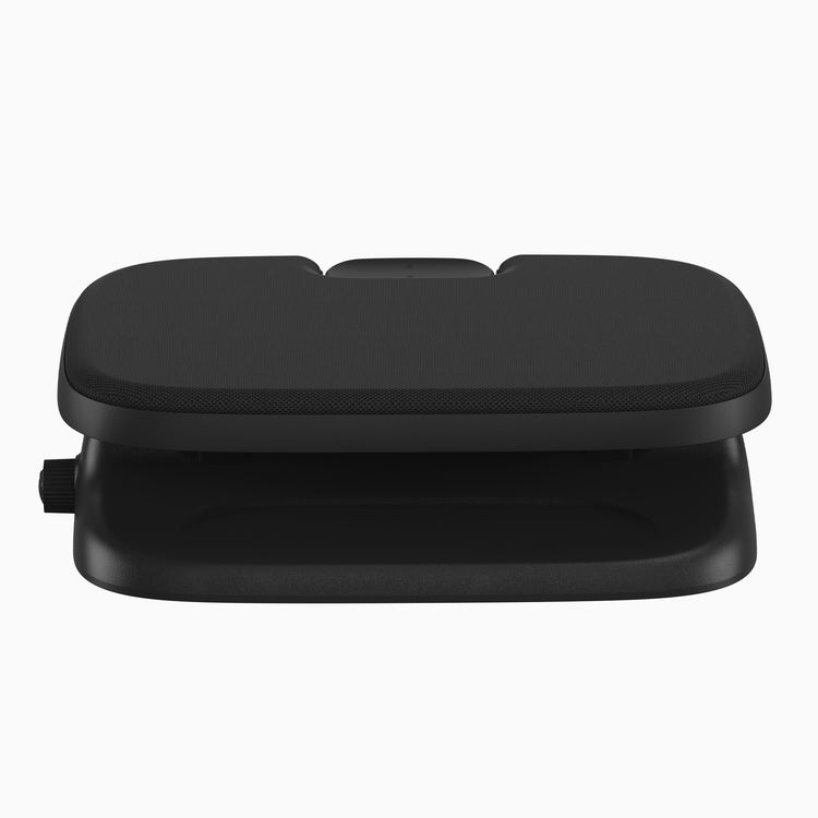 A black ergonomic footrest with a textured top surface and a smooth lower tray, shown on a plain white background.
